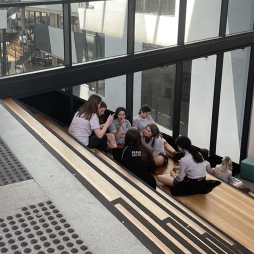 group of friends sitting on stairs