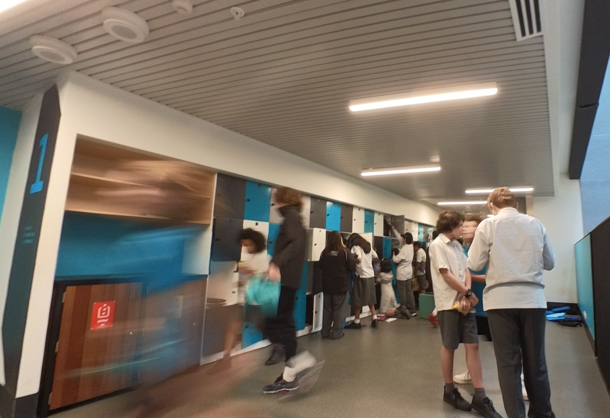 students rushing in front of lockers