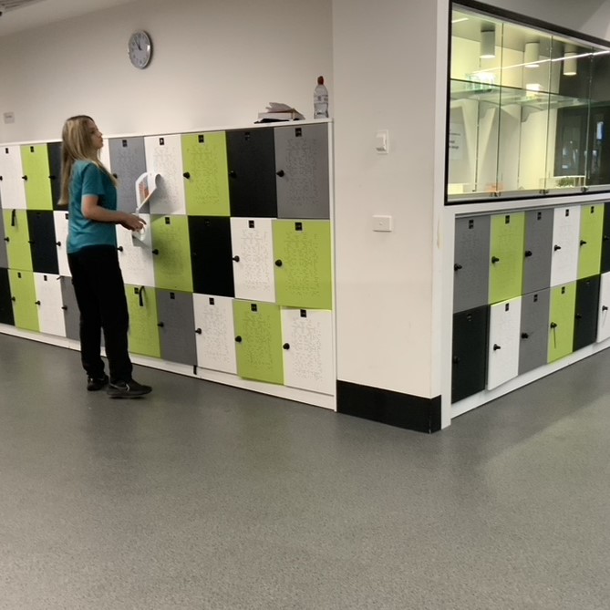 student standing in front of lockers