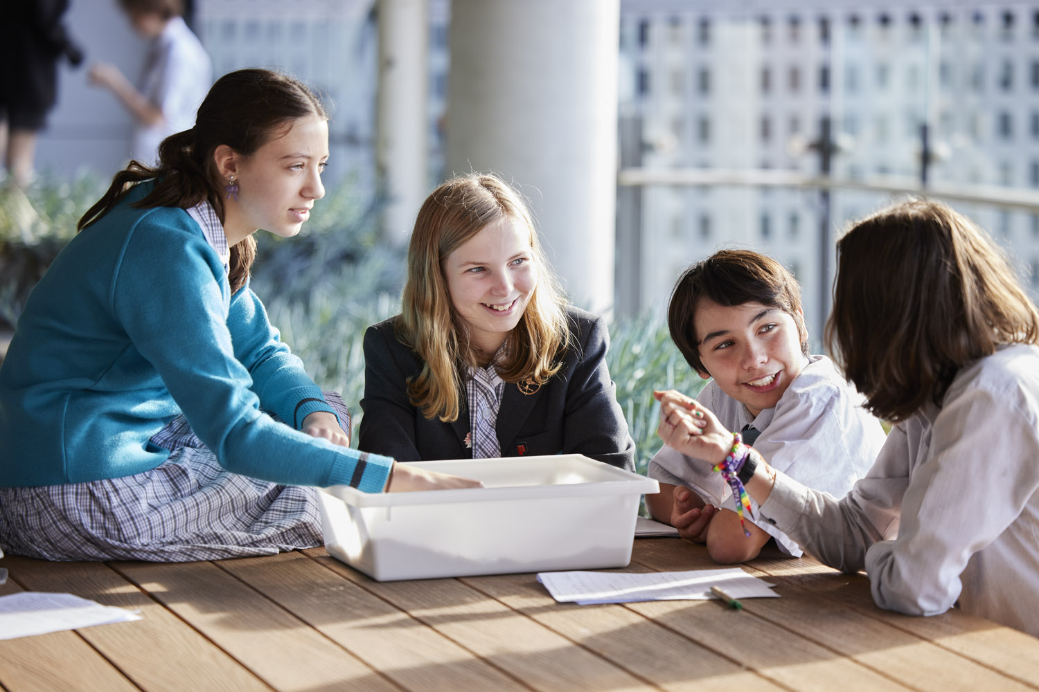 students collaborating on a balcony